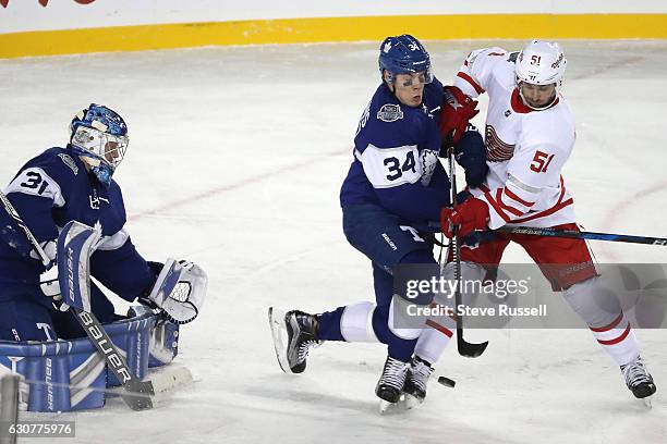 Auston Matthews ties up Frans Nielsen in front of Frederik Andersen as the Toronto Maple Leafs beat the Detroit Red Wings 5-4 in overtime the...