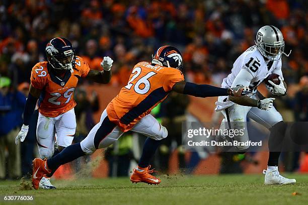 Free safety Darian Stewart of the Denver Broncos tackles wide receiver Michael Crabtree of the Oakland Raiders in the fourth quarter of the game at...