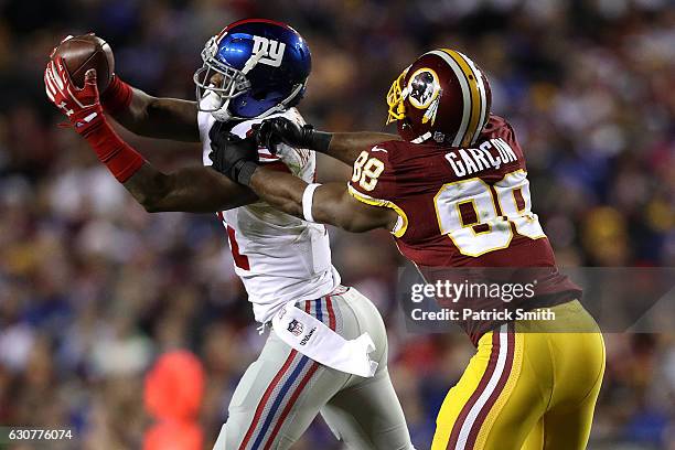 Cornerback Dominique Rodgers-Cromartie of the New York Giants intercepts the ball in front of wide receiver Pierre Garcon of the Washington Redskins...
