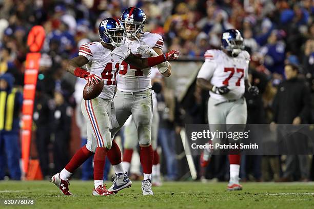 Cornerback Dominique Rodgers-Cromartie of the New York Giants celebrates with teammate outside linebacker Mark Herzlich after intercepting the ball...