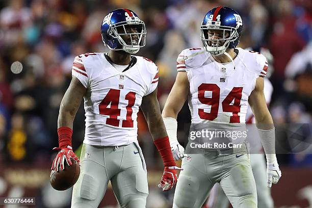 Cornerback Dominique Rodgers-Cromartie of the New York Giants celebrates with teammate outside linebacker Mark Herzlich after intercepting the ball...