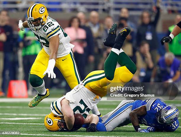Aaron Ripkowski of the Green Bay Packers is tackled by Tavon Wilson of the Detroit Lions during first quarter action at Ford Field on January 1, 2017...