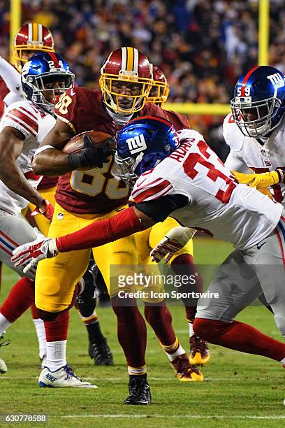 Washington Redskins wide receiver Pierre Garcon makes a pass reception in the fourth quarter against New York Giants free safety Andrew Adams on...