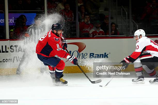 Alex Ovechkin of the Washington Capitals moves the puck against Tom Pyatt of the Ottawa Senators during an NHL hockey game on January 1, 2017 at the...