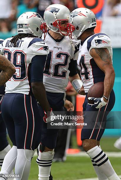Tom brady of the New england Patriots throws a touchdown pass to teammate Michael Floyd against the Miami Dolphins at Hard Rock Stadium on January 1,...