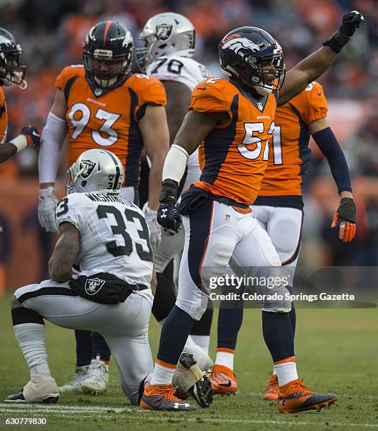 Denver Broncos linebacker Corey Nelson celebrates after Denver stopped Oakland Raiders running back DeAndre Washington short of a first down to force...