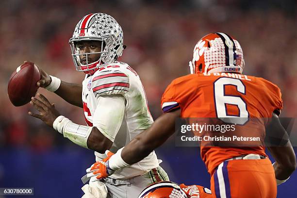 Quarterback J.T. Barrett of the Ohio State Buckeyes scrambles to pass pressured by linebacker Dorian O'Daniel of the Clemson Tigers during the...