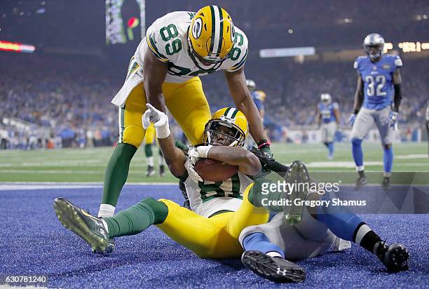 Geronimo Allison of the Green Bay Packers celebrates his touchdown catch with teammate Jared Cook against the Detroit Lions during fourth quarter at...