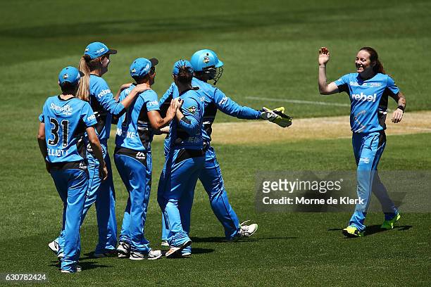 Strikers players celebrate with Sarah Coyte of the Adelaide Strikers after she got the wicket of Ashleigh Gardner of the Sydney Sixers during the...