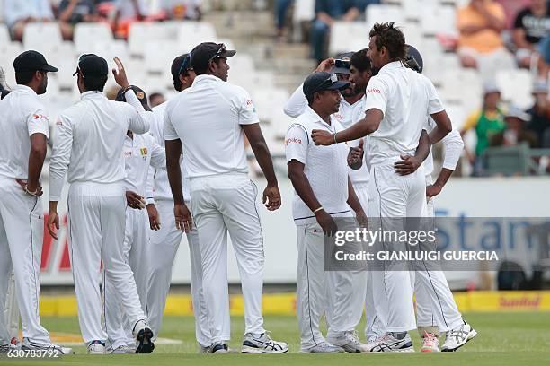 Sri Lanka bowler Suranga Lakmal and players celebrate the dismissal of South African batsman Stephen Cook during the second Test between South Africa...