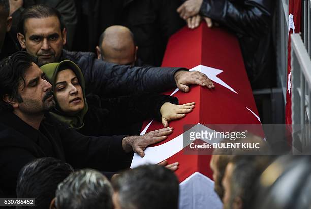 Relatives of security member Fatih Cakmak who died in the Reina night club attack, mourn during the funeral ceremony on January 2, 2017 in Istanbul....