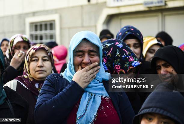 Relatives of security member Fatih Cakmak one of the victims of the Reina night club attack, mourn during the funeral ceremony on January 2, 2017 in...