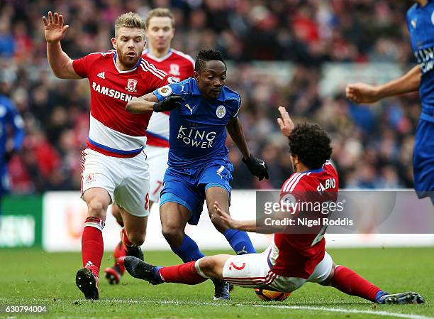 Ahmed Musa of Leicester City attempts to tackle the ball past Adam Clayton of Middlesbrough and Fabio Da Silva of Middlesbrough during the Premier...