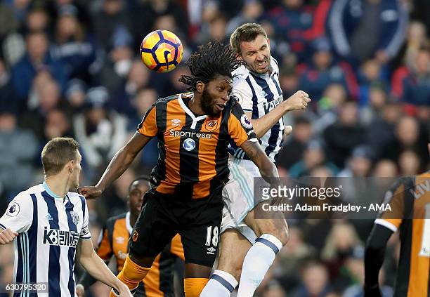 Dieumerci Mbokani of Hull City and Gareth McAuley of West Bromwich Albion during the Premier League match between West Bromwich Albion and Hull City...