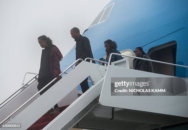 President Barack Obama , First Lady Michelle Obama and daughters Sasha and Malia walk off Air Force One at Andrews Air Force Base in Maryland on...