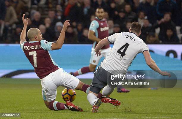 Sofiane Feghouli of West Ham United makes a challenge on Phil Jones of Manchester United that gets a straight red card during the Premier League...