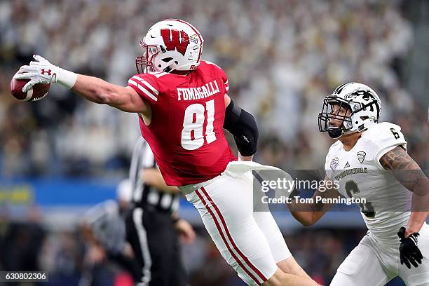 Troy Fumagalli of the Wisconsin Badgers dives for the ball in the first quarter during the 81st Goodyear Cotton Bowl Classic between Western Michigan...