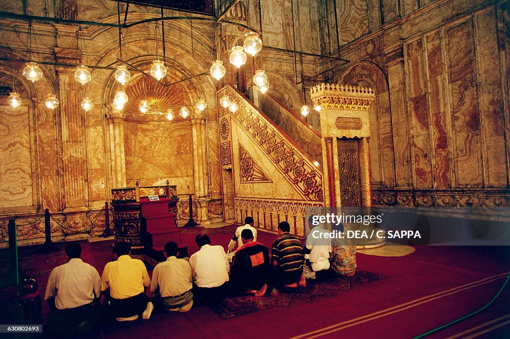 Men praying in the Mosque of Muhammad Ali, Cairo...