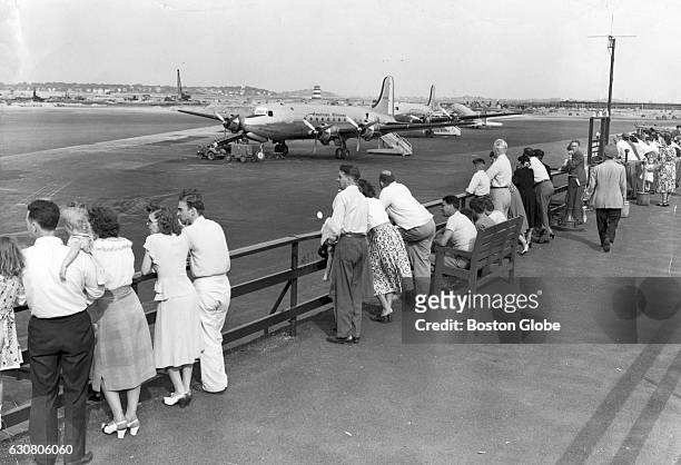 For just the cost of a dime, people could watch the arrival and departure of aircraft at Logan International Airport, August 1948. A broad view of...