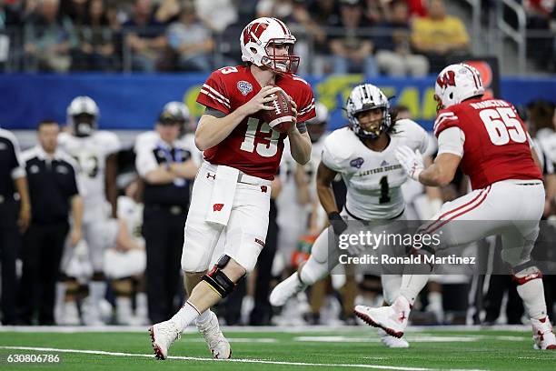 Bart Houston of the Wisconsin Badgers drops back to pass in the third quarter during the 81st Goodyear Cotton Bowl Classic between Western Michigan...