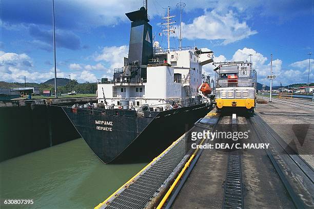 Cargo ship being guided by a mula in the Miraflores lock, Panama canal, Panama.