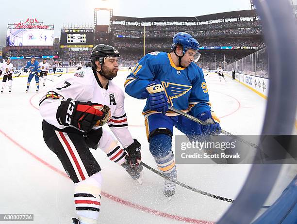 Brent Seabrook of the Chicago Blackhawks and Vladimir Tarasenko of the St. Louis Blues battle for the puck during the 2017 Bridgestone NHL Winter...