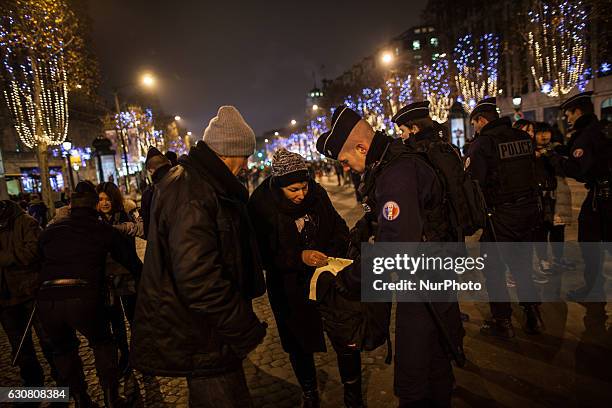 French police carry out security checks on the Avenue des Champs-Élysées on the New Year's Eve in Paris / December 31st 2016.