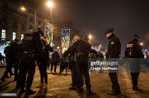 French police carry out security checks on the Avenue des Champs-Élysées on the New Year's Eve in Paris / December 31st 2016.