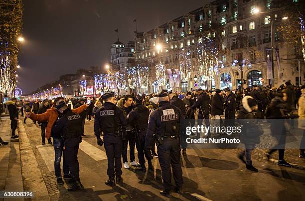 French police carry out security checks on the Avenue des Champs-Élysées on the New Year's Eve in Paris / December 31st 2016.