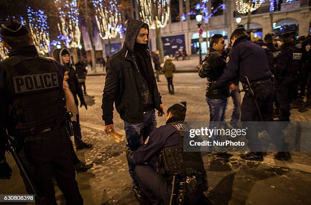 French police carry out security checks on the Avenue des Champs-Élysées on the New Year's Eve in Paris / December 31st 2016.