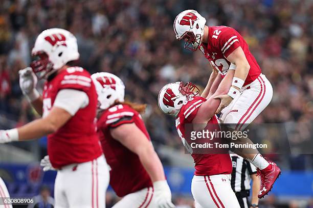 Alex Hornibrook and Zack Baun of the Wisconsin Badgers celebrate after a touchdown in the fourth quarter during the 81st Goodyear Cotton Bowl Classic...