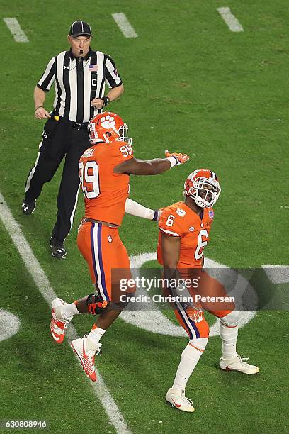 Linebacker Dorian O'Daniel of the Clemson Tigers is congratulated by defensive end Clelin Ferrell after a stop against Ohio State Buckeyes during the...