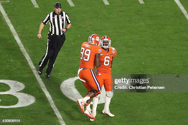 Linebacker Dorian O'Daniel of the Clemson Tigers is congratulated by defensive end Clelin Ferrell after a stop against Ohio State Buckeyes during the...