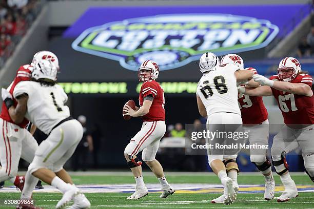 Bart Houston of the Wisconsin Badgers looks to throw in the fourth quarter during the 81st Goodyear Cotton Bowl Classic between Western Michigan and...