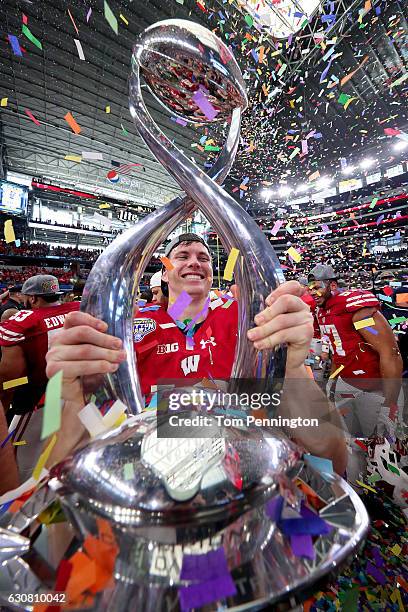 Bart Houston of the Wisconsin Badgers celebrates with the trophy after the Wisconsin Badgers beat the Western Michigan Broncos 24-16 in the 81st...