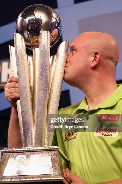 Michael van Gerwen of The Netherlands kisses the trophy after winning the final of the 2017 William Hill PDC World Darts Championships at Alexandra...