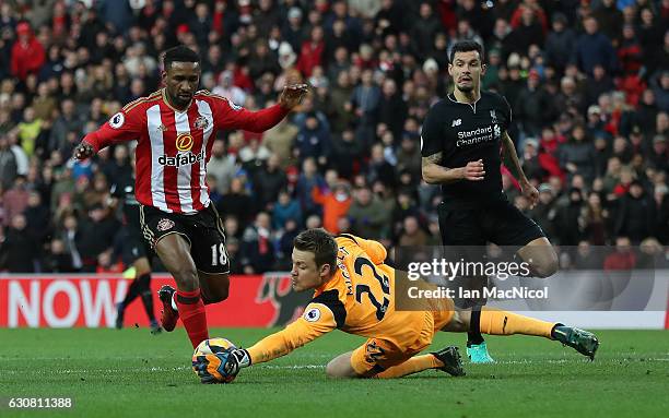 Jermain Defoe of Sunderland vies with Simon Mignolet of Liverpool during the Premier League match between Sunderland and Liverpool at Stadium of...