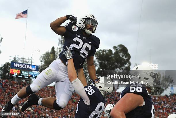 Running back Saquon Barkley of the Penn State Nittany Lions celebrates with tight end Mike Gesicki after scoring on a 24-yard touchdown run in the...