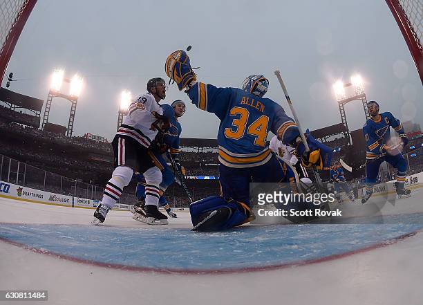 Jake Allen of the St. Louis Blues makes a save against the Chicago Blackhawks during the 2017 Bridgestone NHL Winter Classic at Busch Stadium on...
