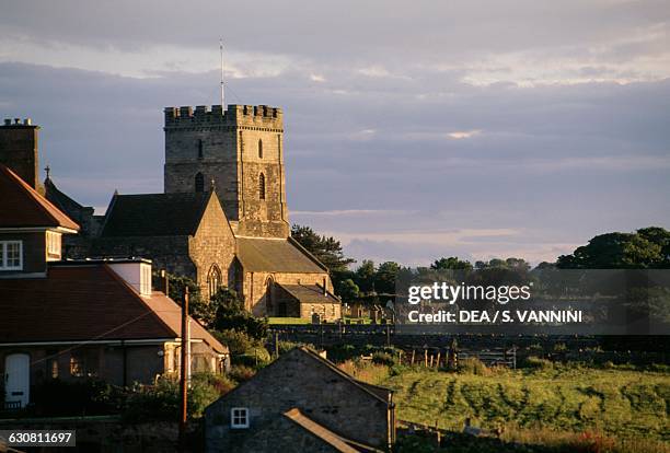 View of Bamburgh, Saint Aidan church in the background, Northumberland, England, United Kingdom.