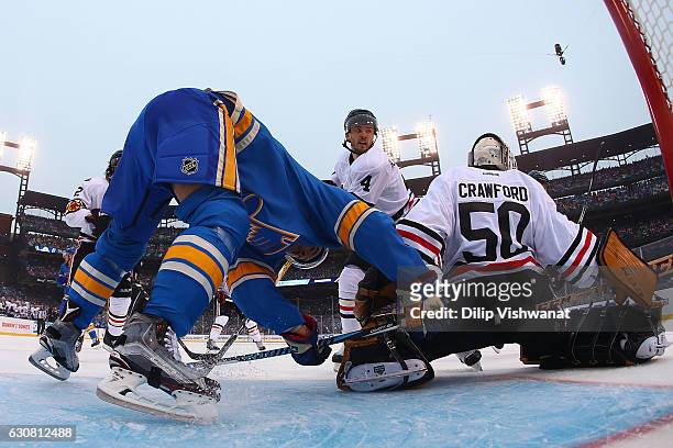 Niklas Hjalmarsson and Corey Crawford of the Chicago Blackhawks defend the goal against Jaden Schwartz of the St. Louis Blues during the 2017...