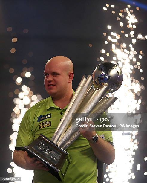 Michael van Gerwen celebrates winning with Sid Waddell trophy during day fifteen of the William Hill World Darts Championship at Alexandra Palace,...