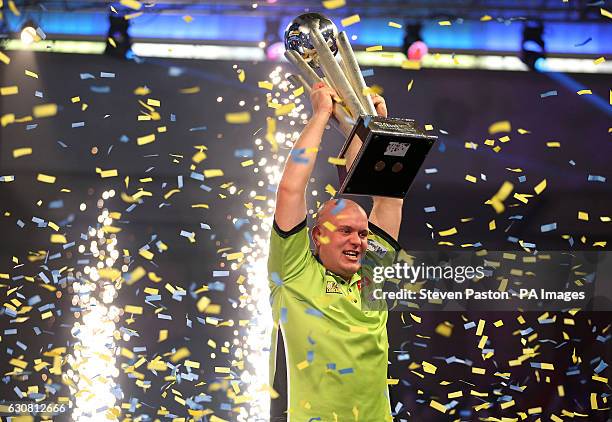 Michael van Gerwen celebrates winning with Sid Waddell trophy during day fifteen of the William Hill World Darts Championship at Alexandra Palace,...