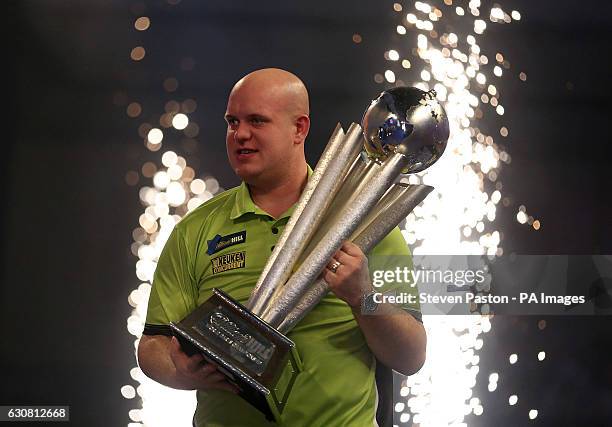 Michael van Gerwen celebrates winning with Sid Waddell trophy during day fifteen of the William Hill World Darts Championship at Alexandra Palace,...