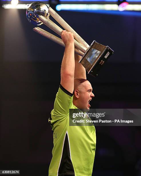 Michael van Gerwen celebrates winning with Sid Waddell trophy during day fifteen of the William Hill World Darts Championship at Alexandra Palace,...