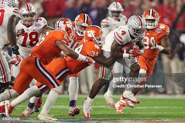 Running back Curtis Samuel of the Ohio State Buckeyes rushes the football past linebacker Kendall Joseph of the Clemson Tigers during the Playstation...