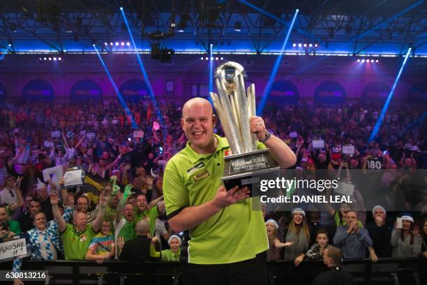 Netherlands' Michael van Gerwen poses for a photograph with the Sid Waddell trophy after his victory in the PDC World Championship darts final over...