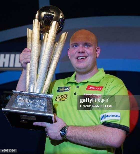 Netherlands' Michael van Gerwen poses for a photograph with the Sid Waddell trophy after his victory in the PDC World Championship darts final over...