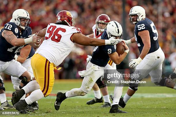 Defensive tackle Stevie Tu'ikolovatu of the USC Trojans attempts to tackle quarterback Trace McSorley of the Penn State Nittany Lions in the first...