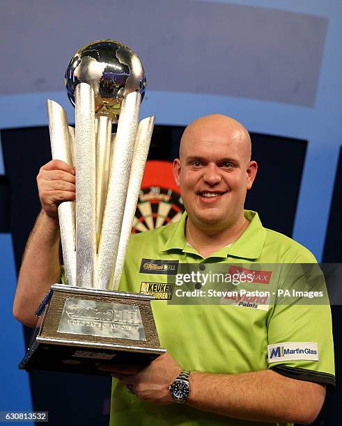 Michael van Gerwen celebrates winning with Sid Waddell trophy during day fifteen of the William Hill World Darts Championship at Alexandra Palace,...